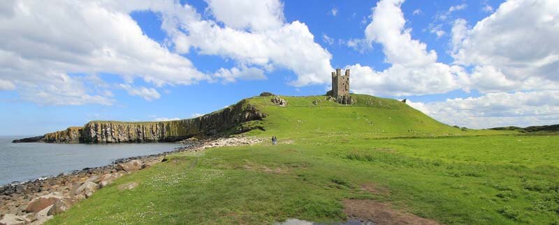 walking up to Dunstanburgh castle on the coastal path in Northumberland
